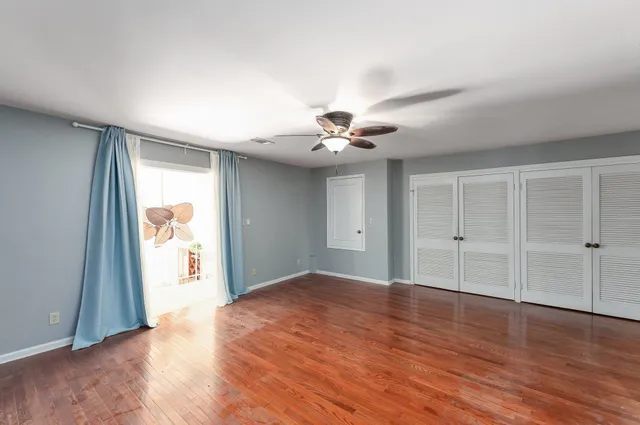 a view of a room with wooden floor and natural light