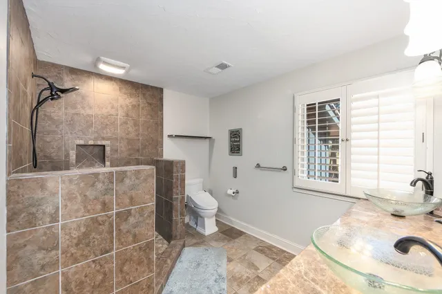 a bathroom with a sink toilet and shower