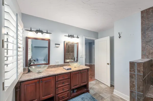 a bathroom with double vanity sinks and a large mirror