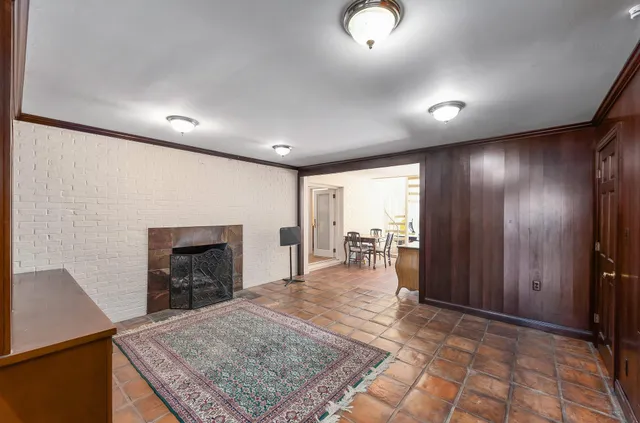 an entryway in a room with a fireplace and dining area