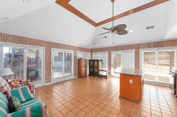 a dining room with furniture and a floor to ceiling window