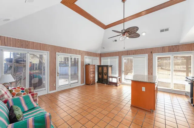 a dining room with furniture and a floor to ceiling window