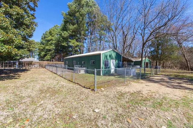 a view of a house with a backyard