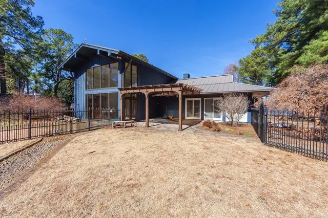 a view of a house with a yard and sitting area