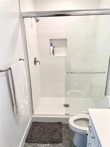 a bathroom with a shower a toilet and a shower