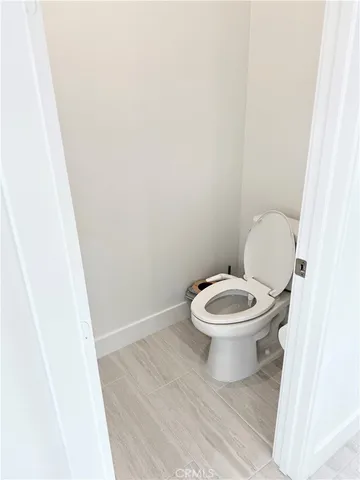 a white toilet sitting next to a white sink