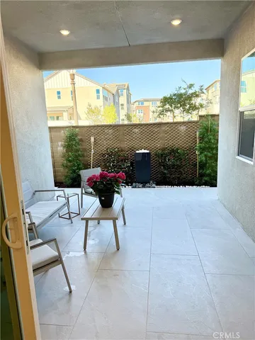 a view of a chairs and table in patio