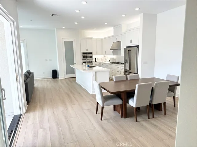 a large kitchen with a table and chairs