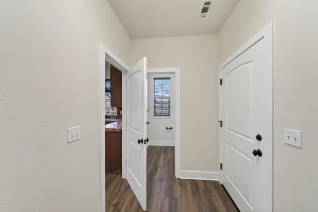 a bathroom with a granite countertop toilet a sink and a mirror