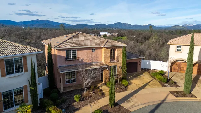 a aerial view of a house with swimming pool and sitting area
