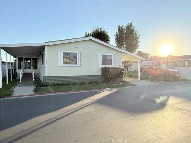 a view of a house with a yard and a garage