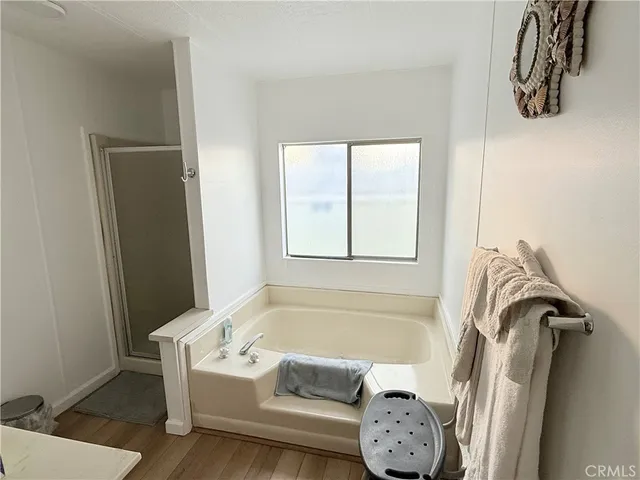 a bedroom with a bed and a flat tv screen on dresser