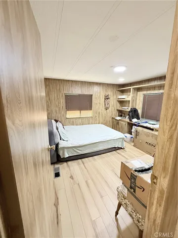 a bed sitting in a bedroom next to a cabinet
