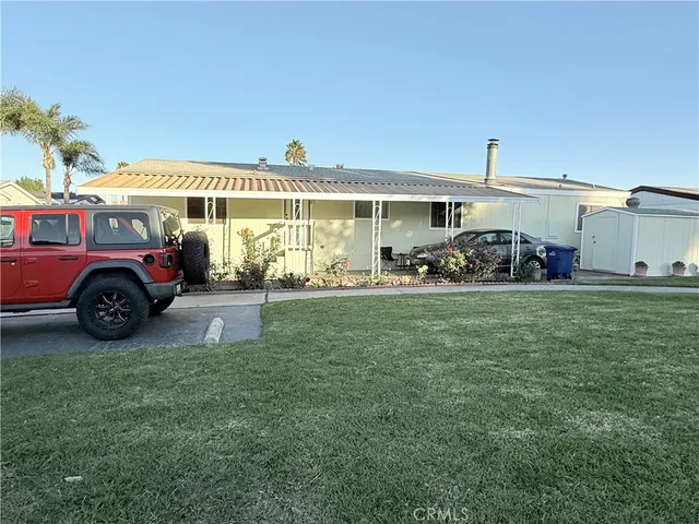 a front view of a house with a garden and parking space
