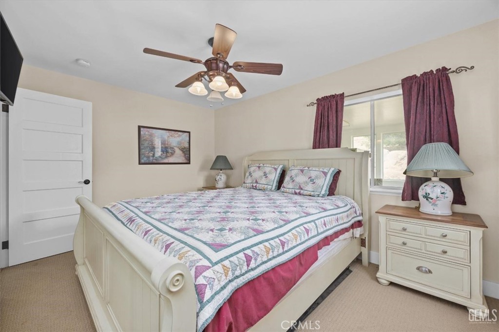 21564 Pine Tree Road Caliente, CA 93518 - Photo 34 of 48 a bedroom with a bed and a chandelier