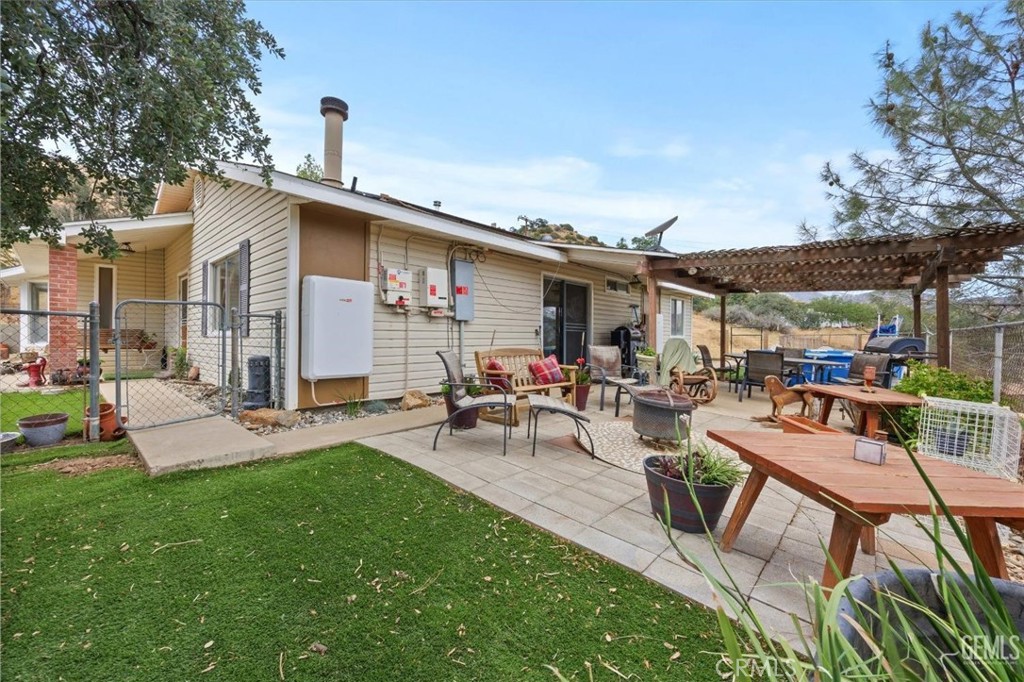 21564 Pine Tree Road Caliente, CA 93518 - Photo 41 of 48 a view of a patio with table and chairs potted plants with wooden fence