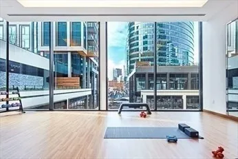a living room filled with furniture and large windows