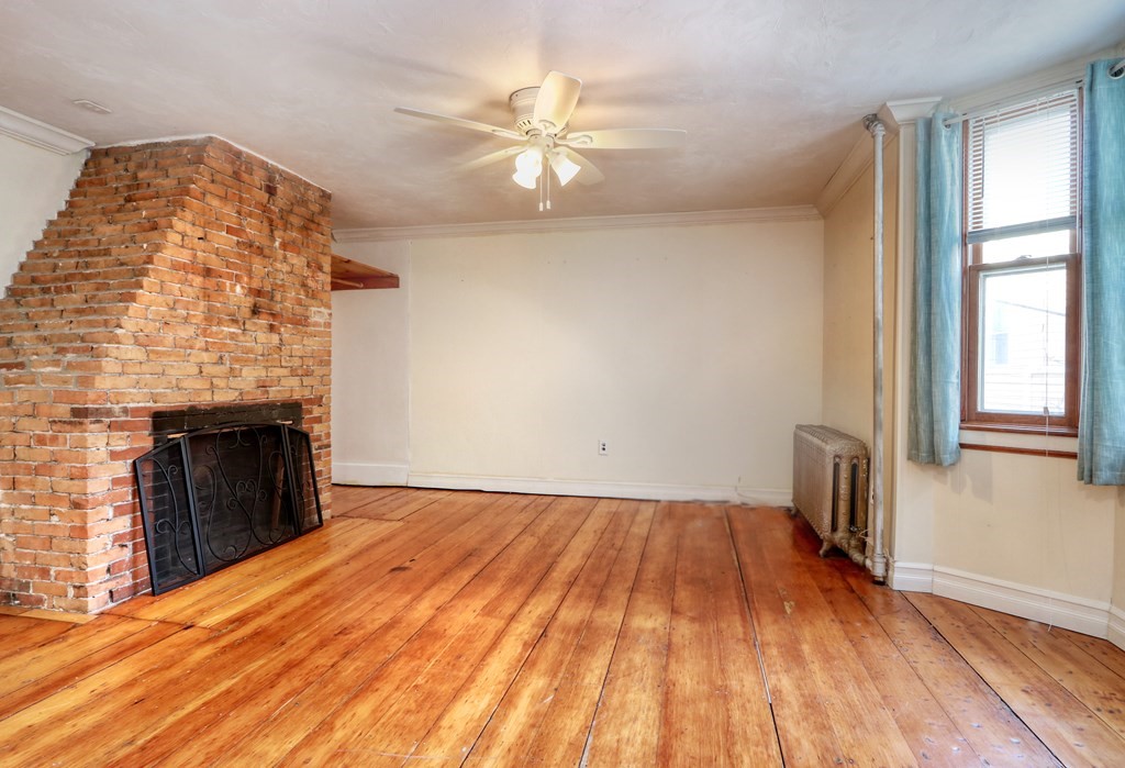 4 Pleasant Street Boston, MA 02129 - Photo 15 of 31 wooden floor fireplace and windows in an empty room