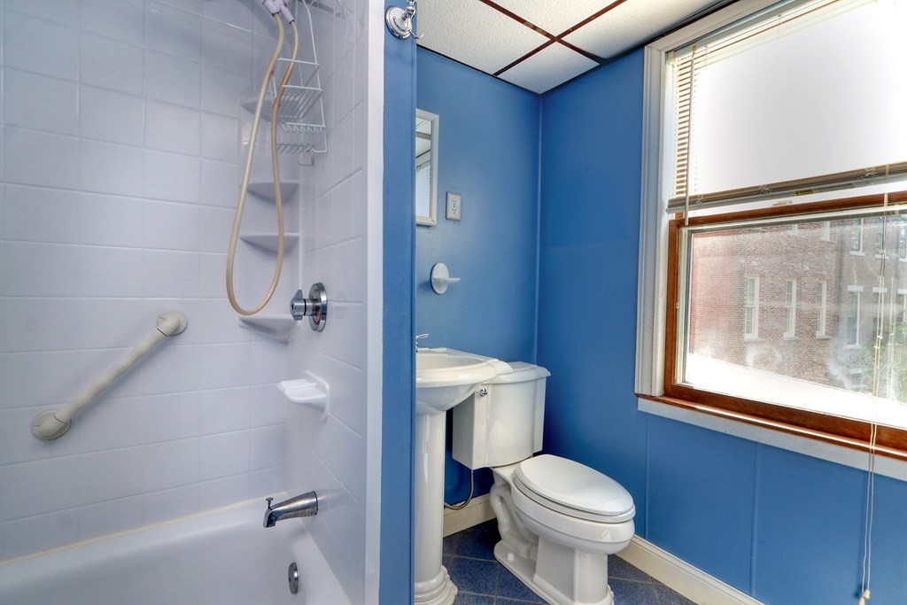 4 Pleasant Street Boston, MA 02129 - Photo 17 of 31 a white toilet sitting next to a bathroom sink and tub