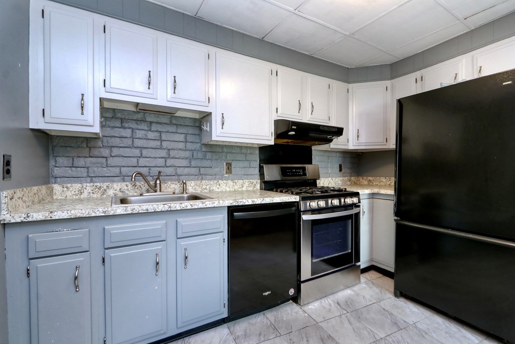 4 Pleasant Street Boston, MA 02129 - Photo 9 of 31 a kitchen with stainless steel appliances granite countertop a stove a refrigerator and a sink