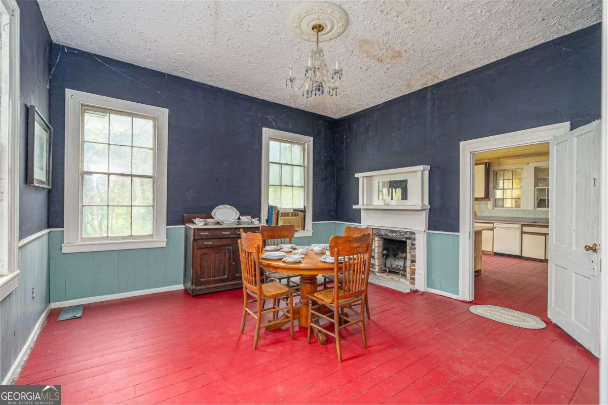 602 Magnolia Street Guyton, GA 31312 - Photo 11 of 34 a view of a dining room with furniture and chandelier