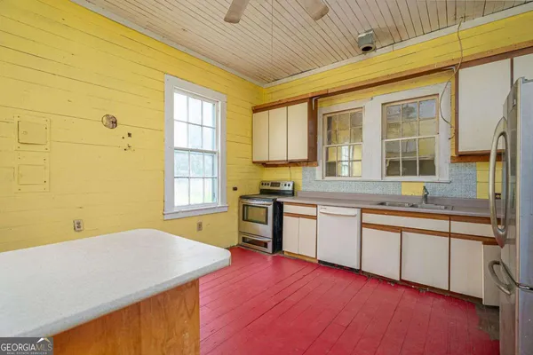 a kitchen with stainless steel appliances granite countertop a stove and a refrigerator