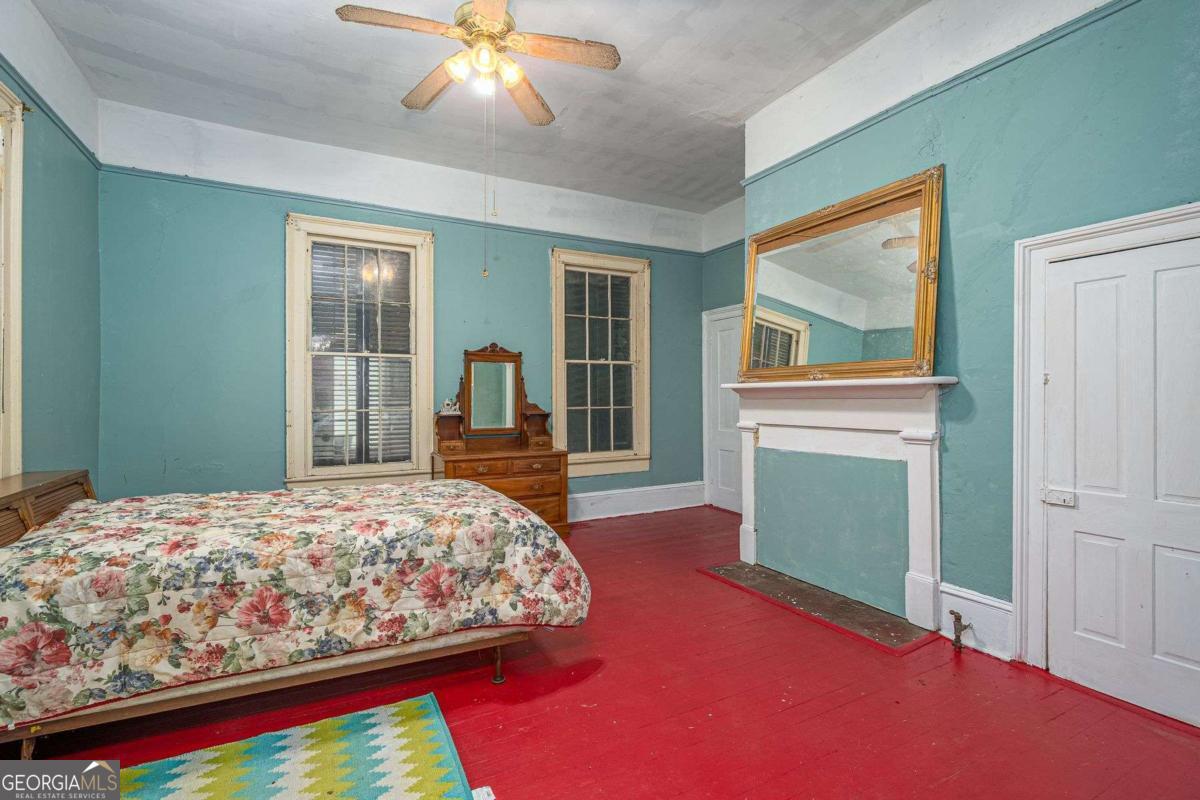 602 Magnolia Street Guyton, GA 31312 - Photo 14 of 34 a bedroom with a bed and a chandelier