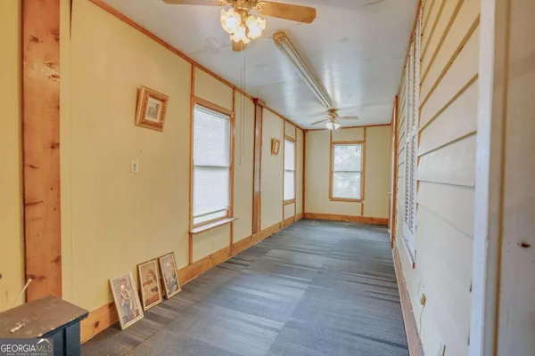 a room with wooden floor and furniture