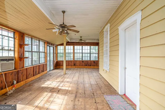 a view of a porch with a table and chairs