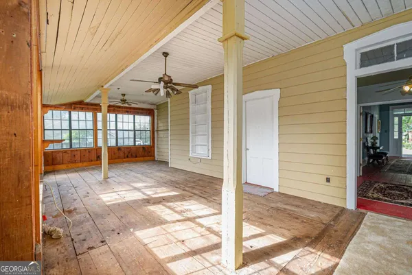 a view of a room with wooden floor and windows