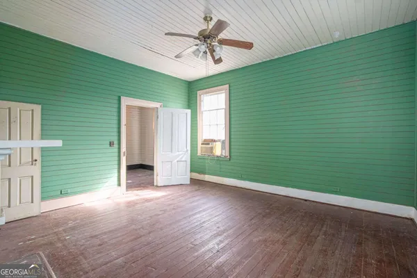 a view of empty room with a fireplace and a window