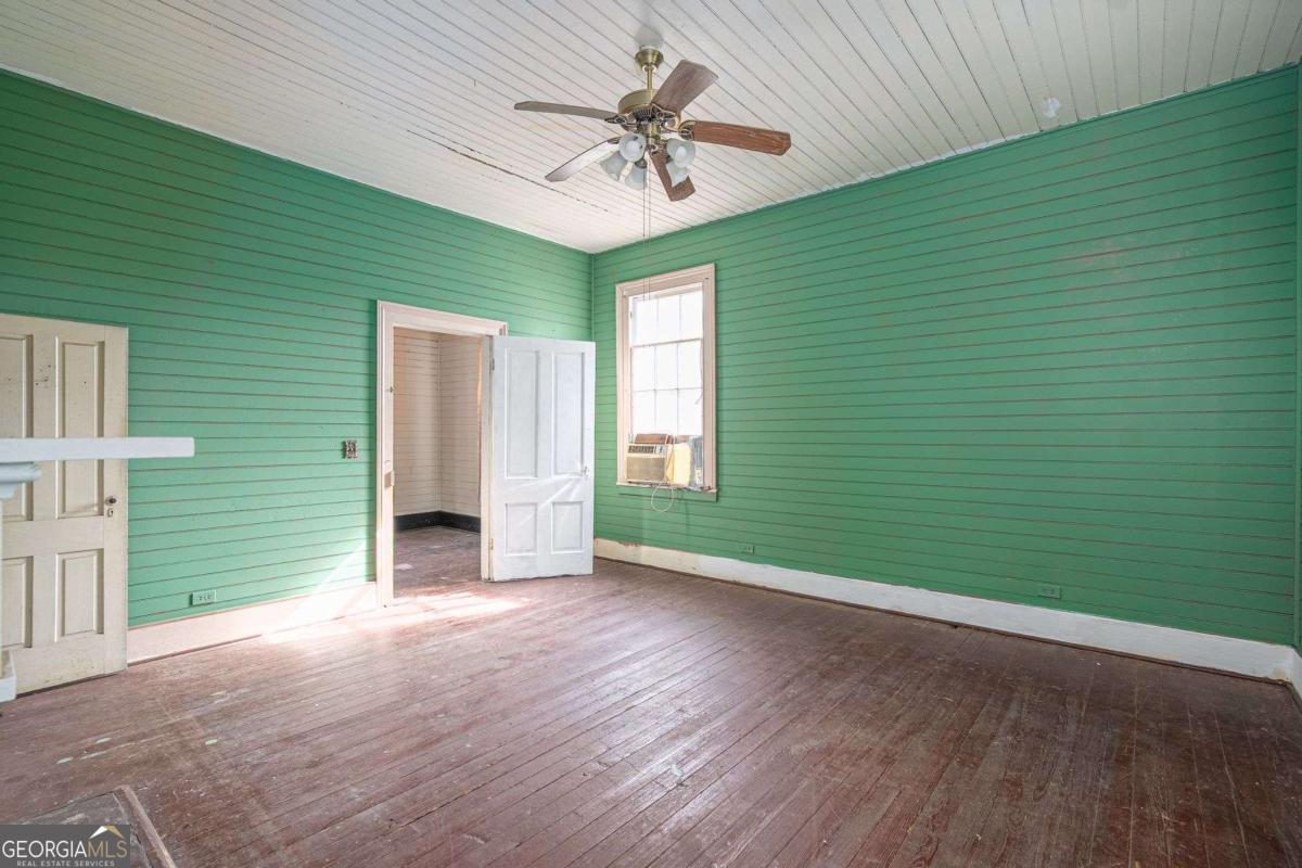 602 Magnolia Street Guyton, GA 31312 - Photo 23 of 34 a view of a livingroom with a ceiling fan and a hardwood floor