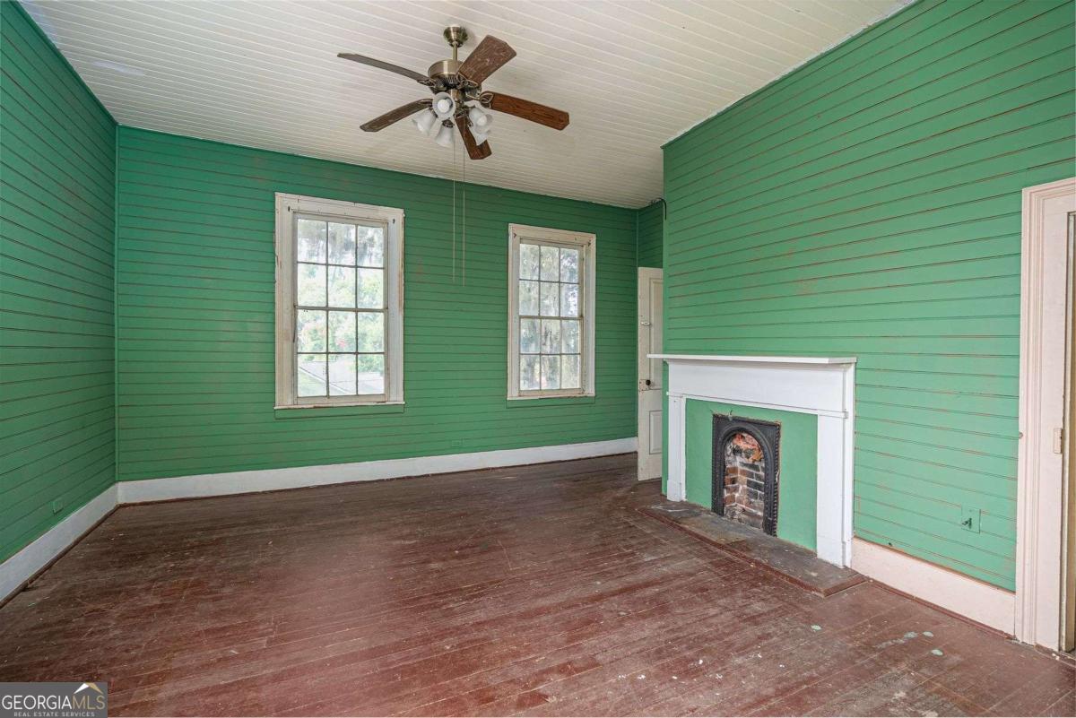 602 Magnolia Street Guyton, GA 31312 - Photo 24 of 34 a view of empty room with a fireplace and a window