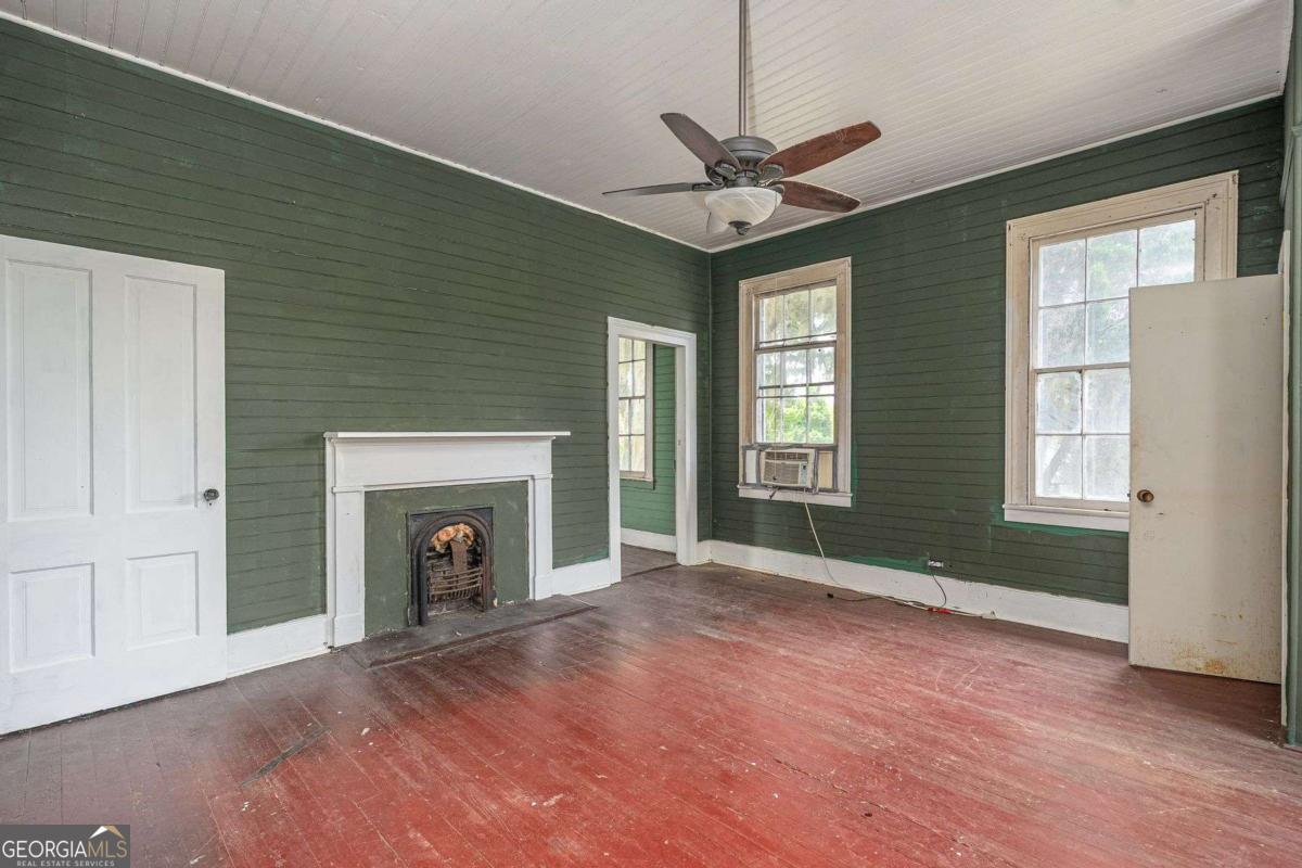 602 Magnolia Street Guyton, GA 31312 - Photo 28 of 34 a view of empty room with fireplace and wooden floor