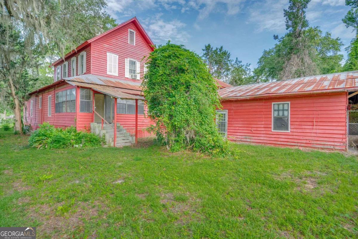 602 Magnolia Street Guyton, GA 31312 - Photo 31 of 34 a front view of a house with a garden