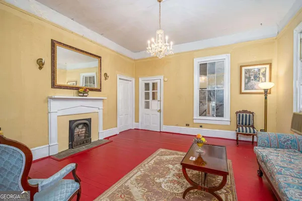 a living room with furniture and a chandelier