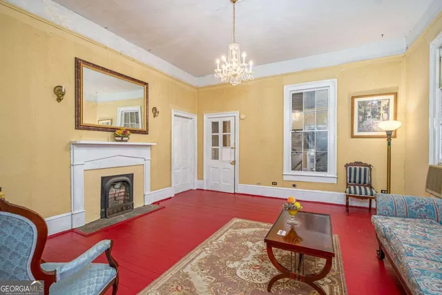 a living room with furniture and a chandelier