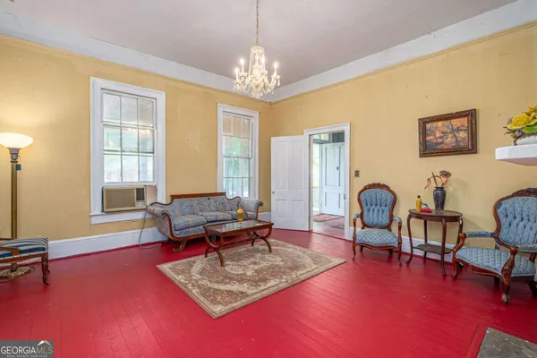 a view of a dining room with furniture and chandelier