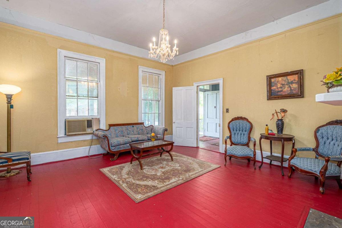 602 Magnolia Street Guyton, GA 31312 - Photo 10 of 34 a living room with furniture and a chandelier