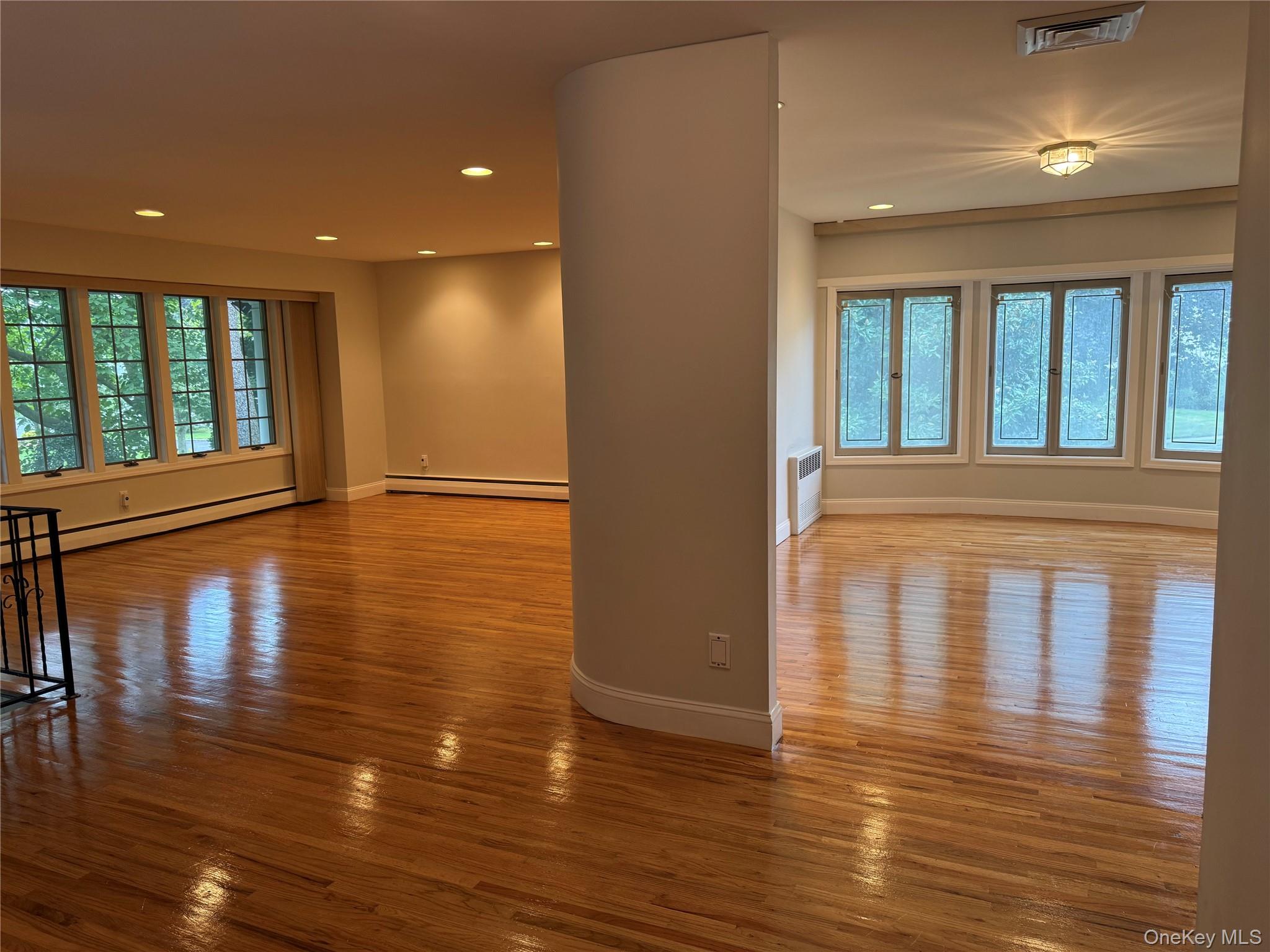 30 Dogwood Road, Unit PVT HOUSE Albertson, NY 11507 - Photo 5 of 15 a view of empty room with wooden floor and fan