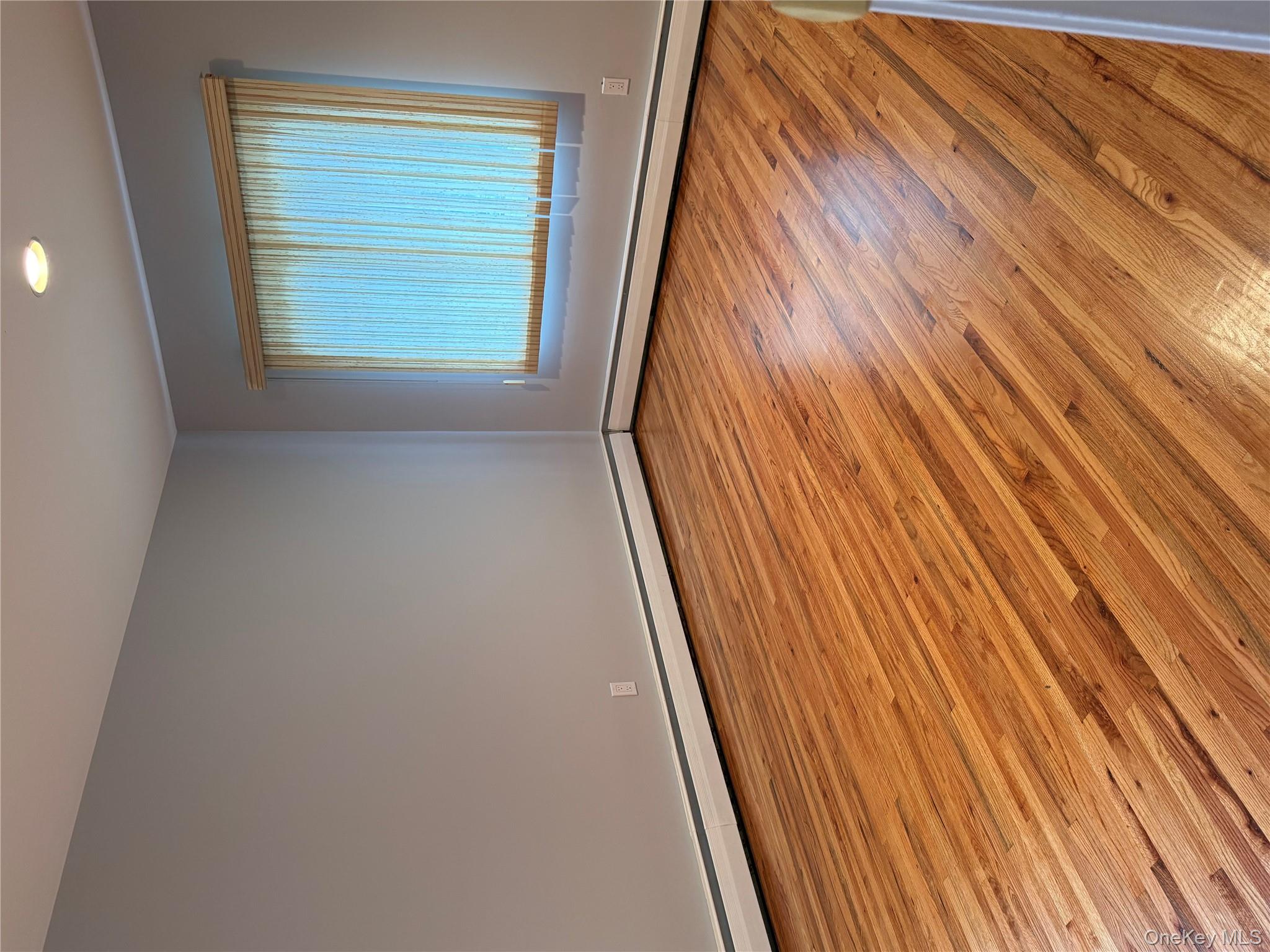 30 Dogwood Road, Unit PVT HOUSE Albertson, NY 11507 - Photo 7 of 15 a view of an empty room with wooden floor and a window