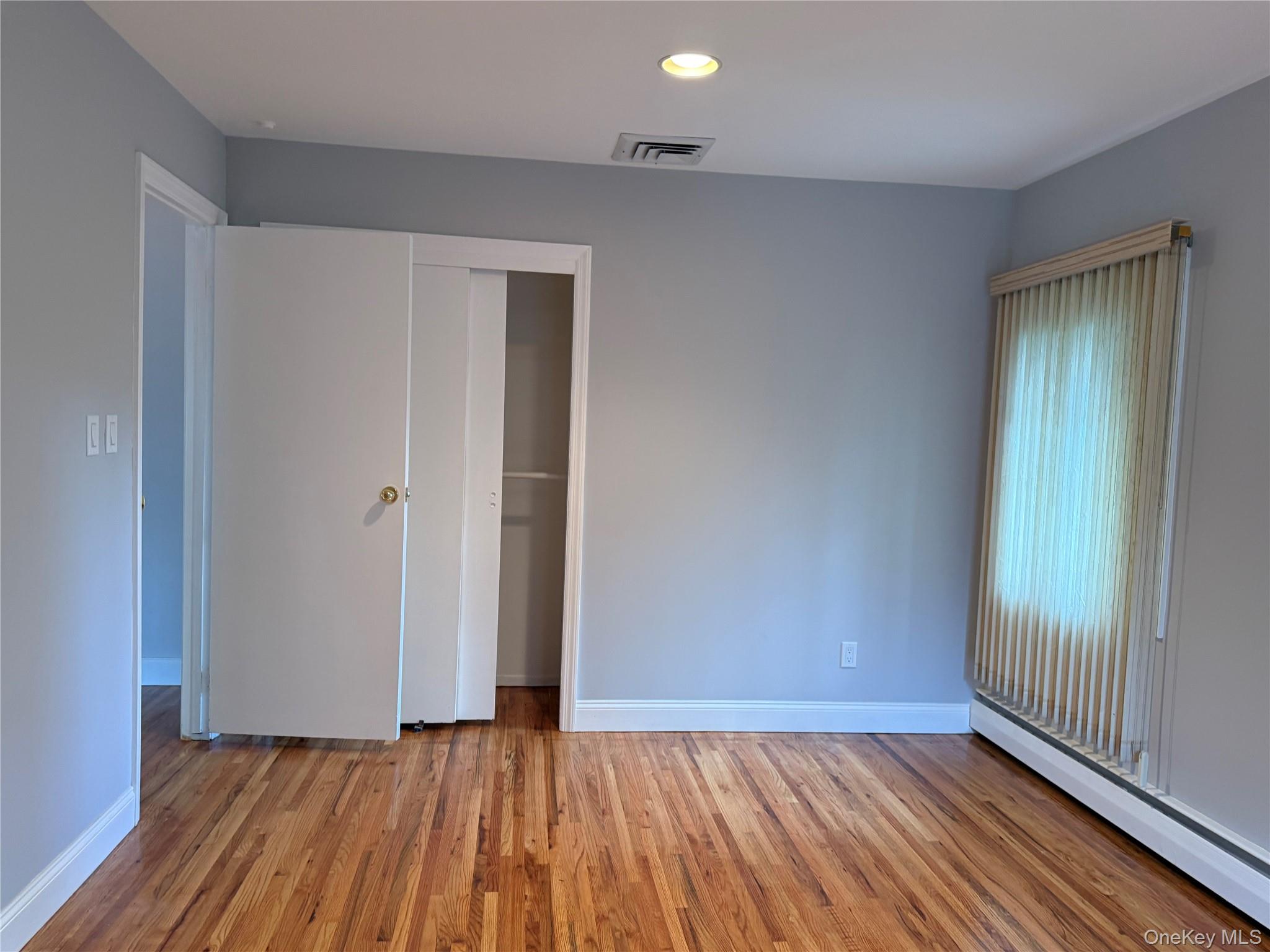 30 Dogwood Road, Unit PVT HOUSE Albertson, NY 11507 - Photo 8 of 15 an empty room with wooden floor and windows