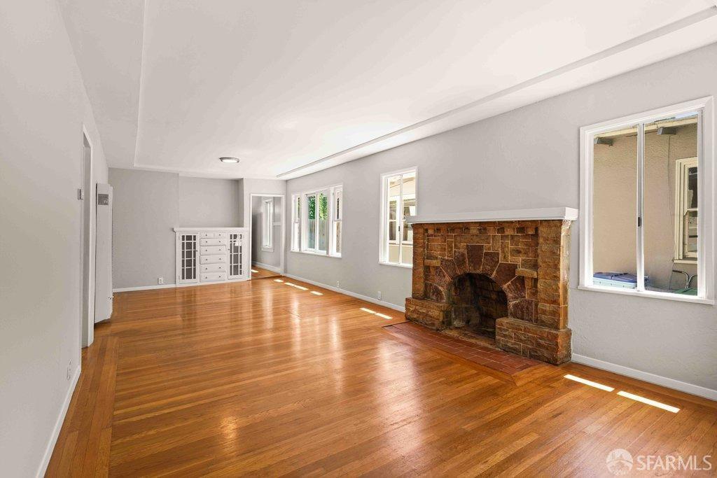 3111 Wheeler Street Berkeley, CA 94705 - Photo 7 of 44 a view of empty room with wooden floor and fireplace