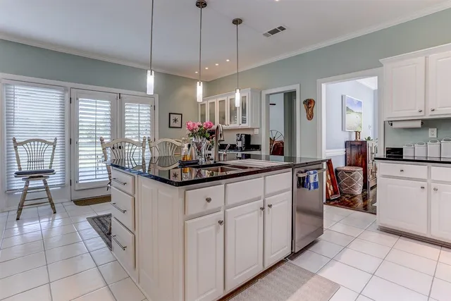 a kitchen with sink cabinets and living room view