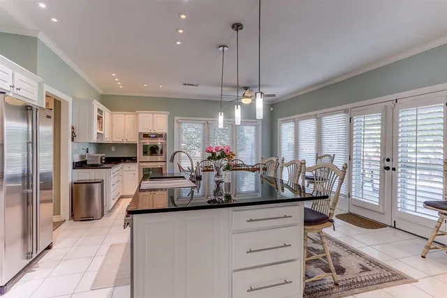 a kitchen with counter top space cabinets and stainless steel appliances