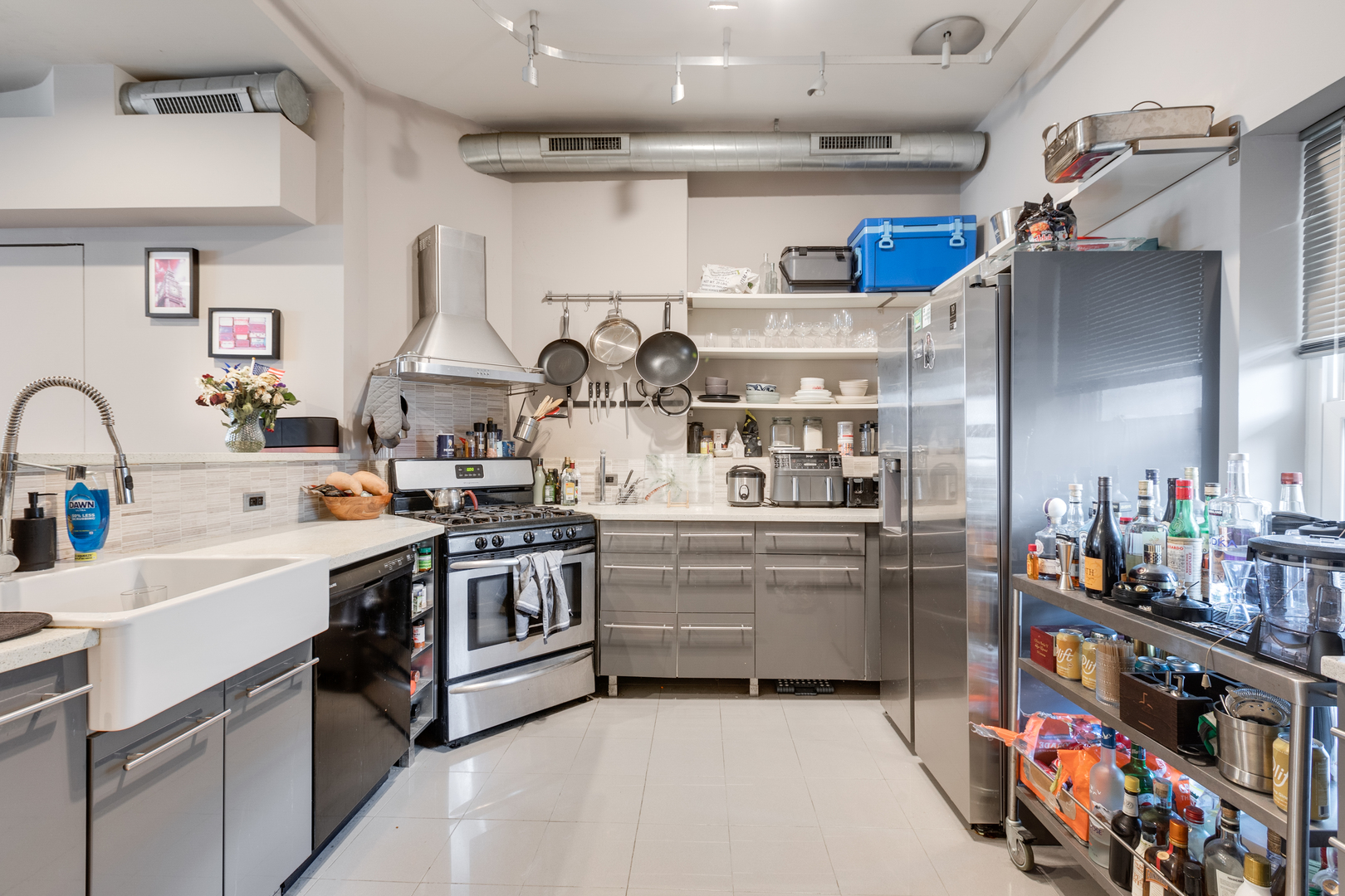 1005 South Racine Avenue Chicago, IL 60607 - Photo 5 of 16 a kitchen with lots of clutter and stainless steel appliances
