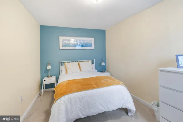 a bedroom with a bed and a table