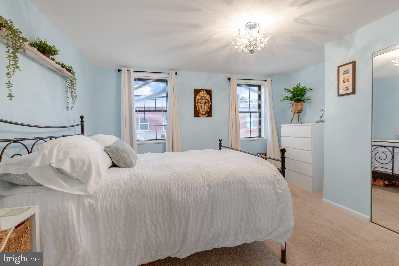 1006 Morris Street Philadelphia, PA 19148 - Photo 19 of 24 a bedroom with a bed and a chandelier