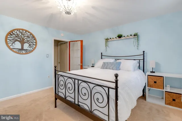 a bedroom with a bed and a chandelier