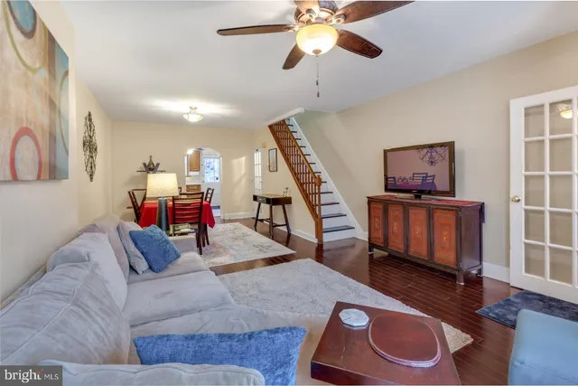 a living room with furniture and wooden floor